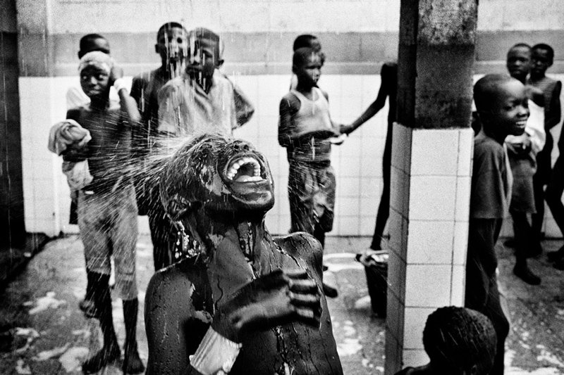 Marcus Bleasdale - Children are seen washing at a center for street kids in Kinshasa