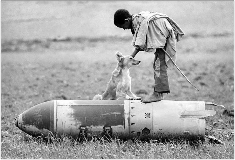 Dario Mitidieri - Boy and dog on unexploded bomb, Tigray, Ethiopia 1991