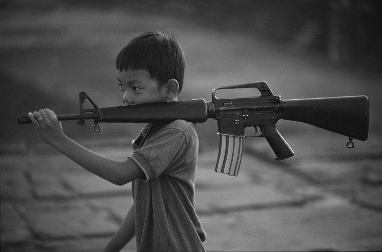 Philip Jones Griffiths - Boy with gun, Cambodia 1973
