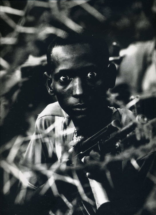 Philip Jones Griffiths - Dinka people look after the family cattle, when government soldiers massacre the inhabitants, the boys takes arms, Sudan 1980