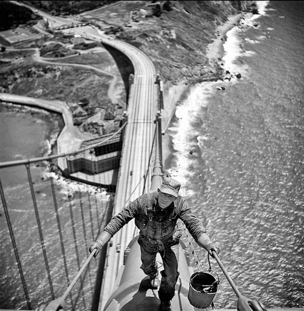 Fred Lyon - San Francisco Golden Gate Bridge painter walking up main cable, 1947