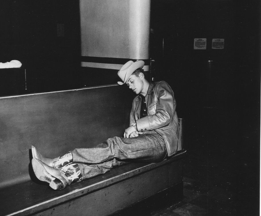 Weegee - A cowboy asleep on a bench in a bus station in Denver, Colorado 1960