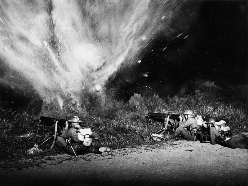 John Warwick Brooke - Machine gunners firing during which a mine explodes, France 1916-1918