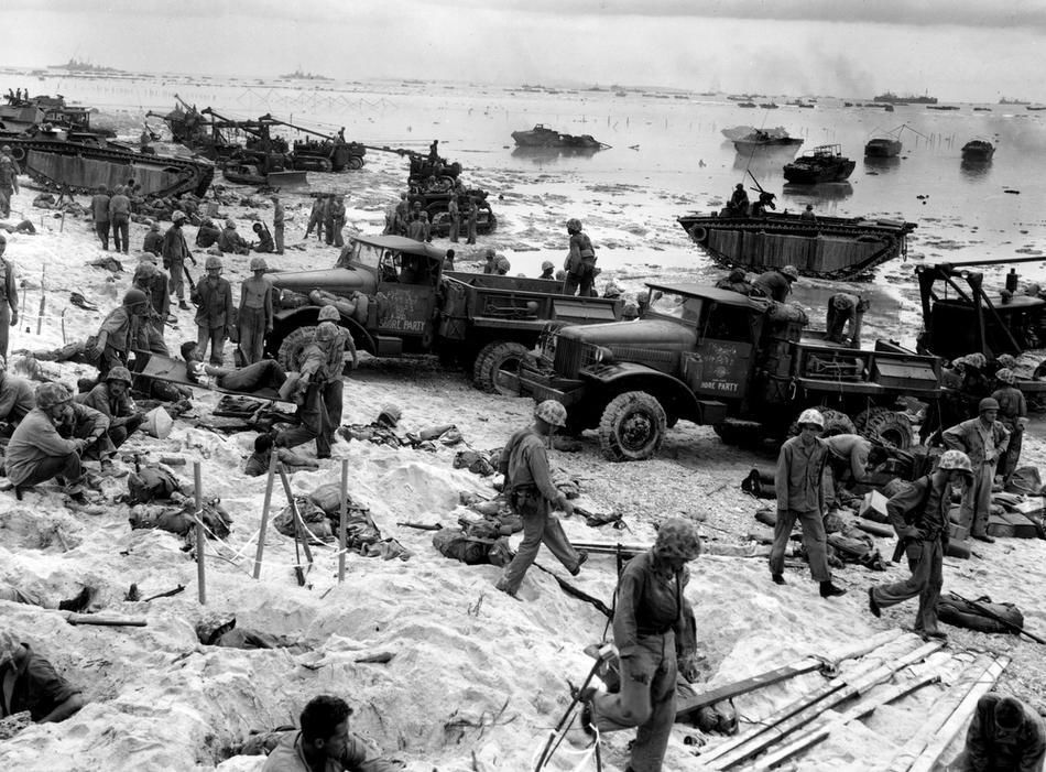 Joe Rosenthal - As the invasion of Peleliu gets underway, US Marines unload war supplies and ammunition boxes onto the beach of the island in the Palau group 1944
