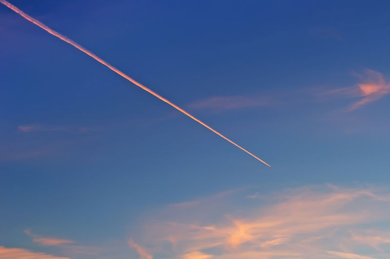 Chemtrail Streak across the sky at sunset