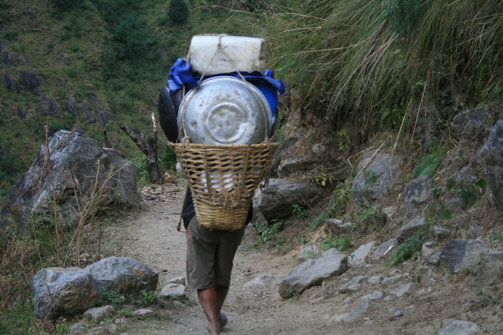 A KITCHEN PORTER HEADS FOR THE NEXT CAMP.