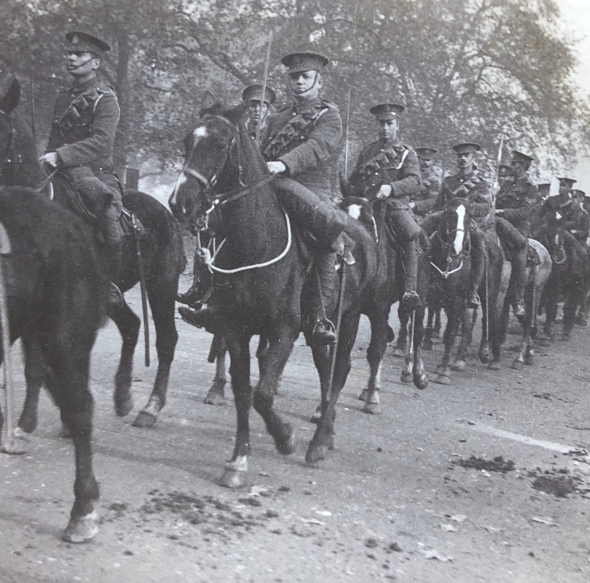 A panel of a stereoscopic postcard of a mounted section of King Edward’s Horse wearing Service Dress equipped with 1899 pattern cavalry swords and 1903-pattern, Mounted Infantry leather 50 round .303 bandoliers for their .303 SMLE Mark 1 rifles and wear white lanyards around their left shoulders circa 1914.