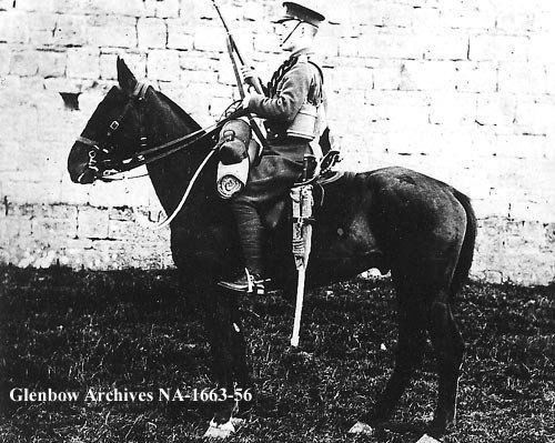 A trooper, 1st King Edward's Horse (The King's Oversea Dominions Regiment), Longford, Ireland. Mounted on horseback, holding rifle. "A trooper, 1st King Edward's Horse (The King's Oversea Dominions Regiment), Ireland.", 1916, (CU184511) by Unknown. Courtesy of Glenbow Library and Archives Collection, Libraries and Cultural Resources Digital Collections, University of Calgary