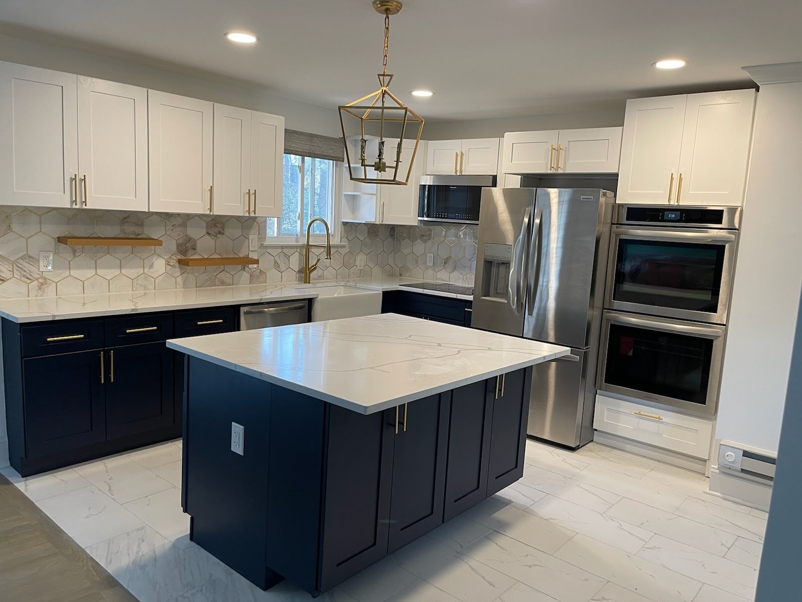 White Shaker and Blue Shaker Cabinets with Calacatta Countertop