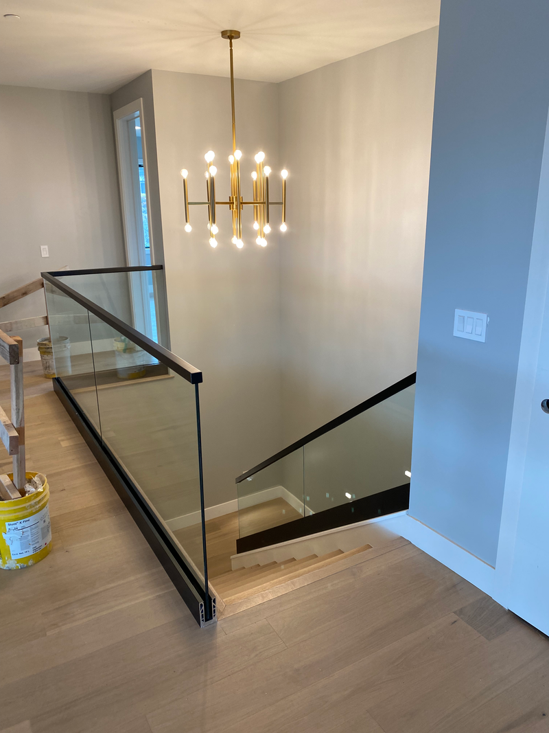 Glass railing with top rail mounted with Standoffs. Matte black finish
