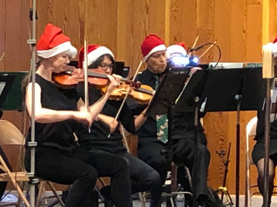 Some serious looking Santas in the violin section!