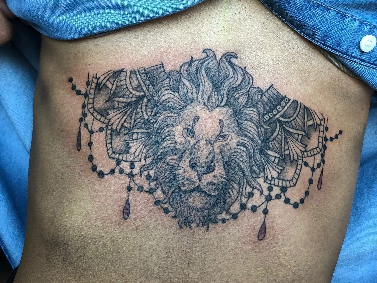 Lion Themed Underboob Tattoo