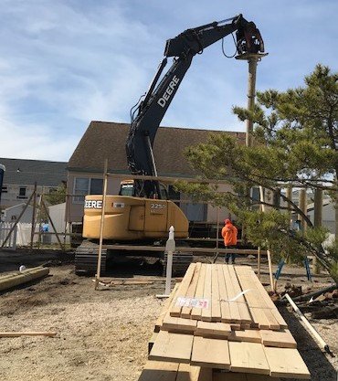 Piling install for a house raise on 6th St in Surf City