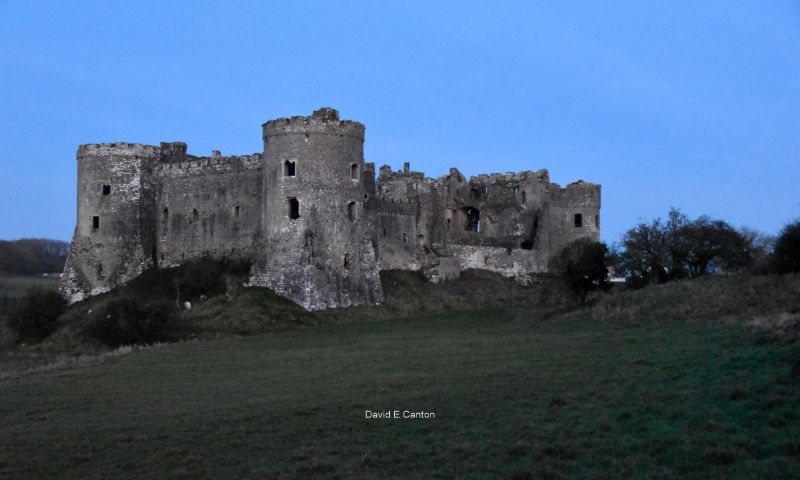 Carew Castle in Pembrokeshire in blue light.