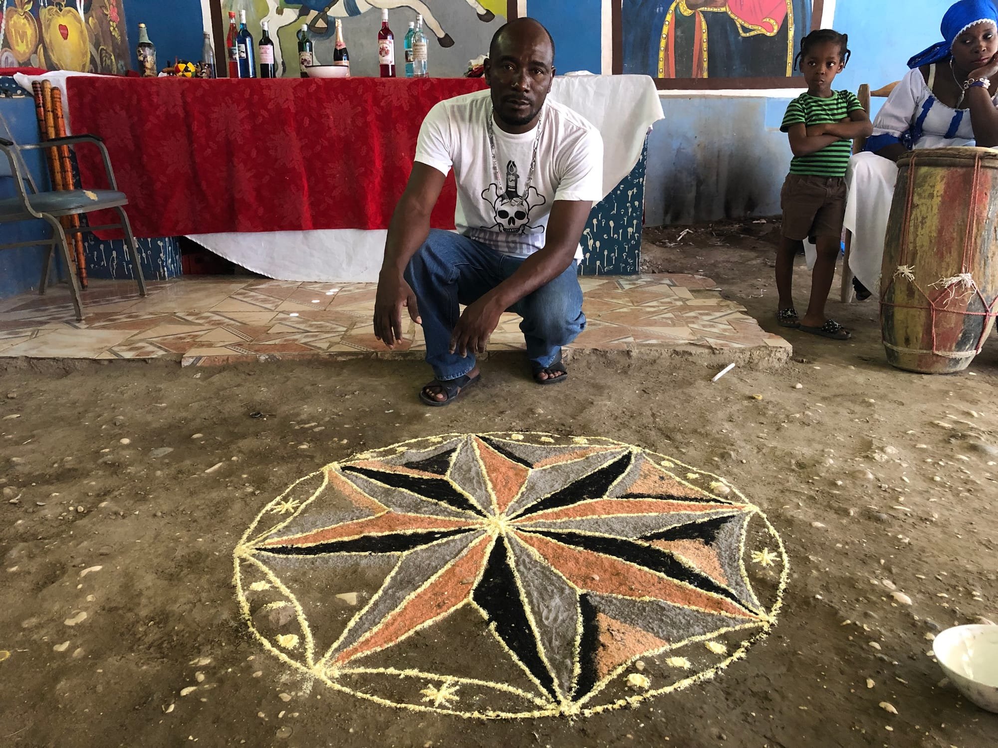 Minister of Vodou, Ouest Department, Victor Boniface with a veve he has drawn with cornmeal for Milocan.