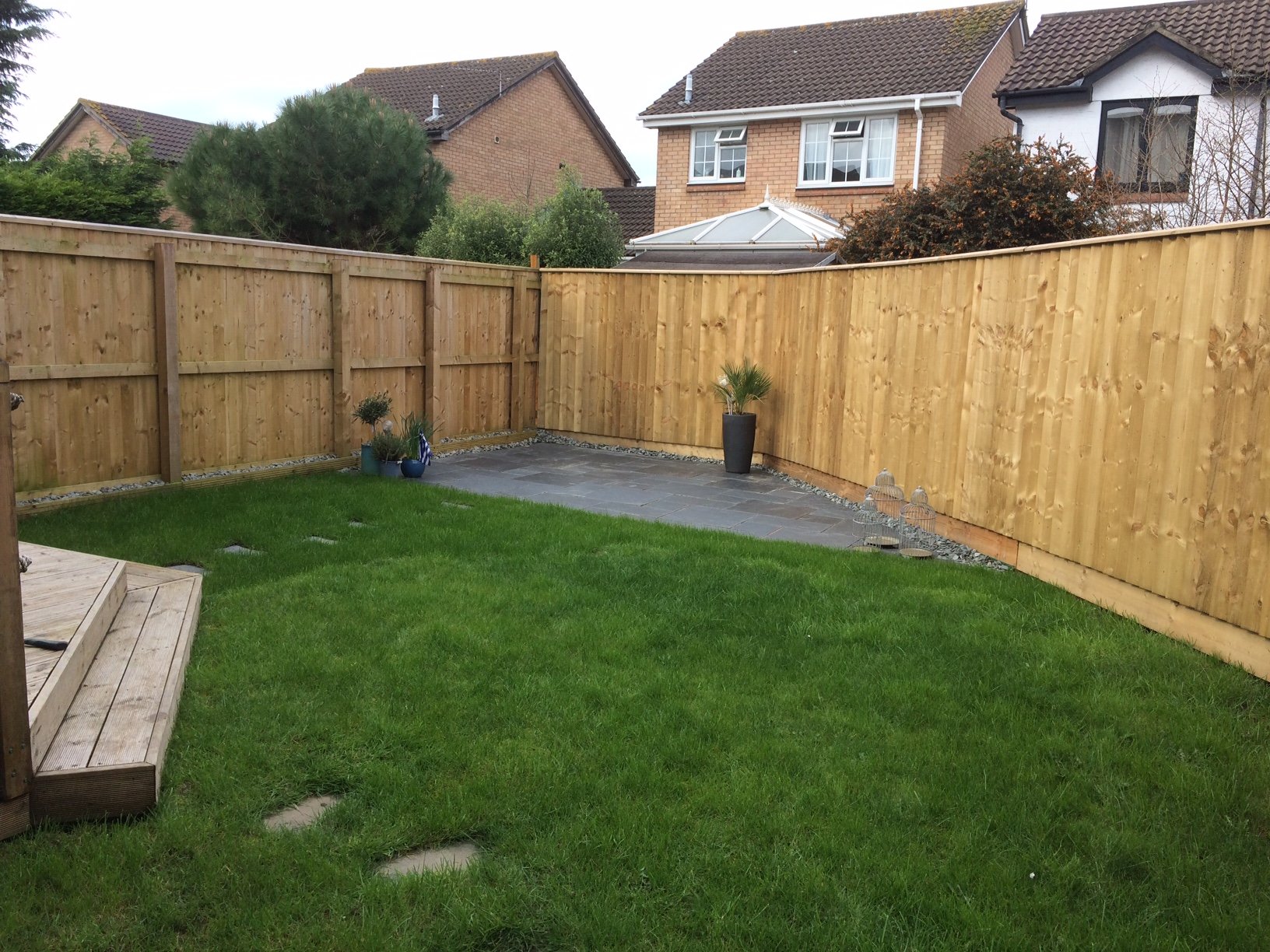 Feather edge fencing and slate patio