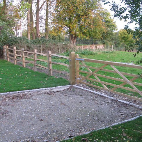 Chestnut post and rail fencing with five bar field gate