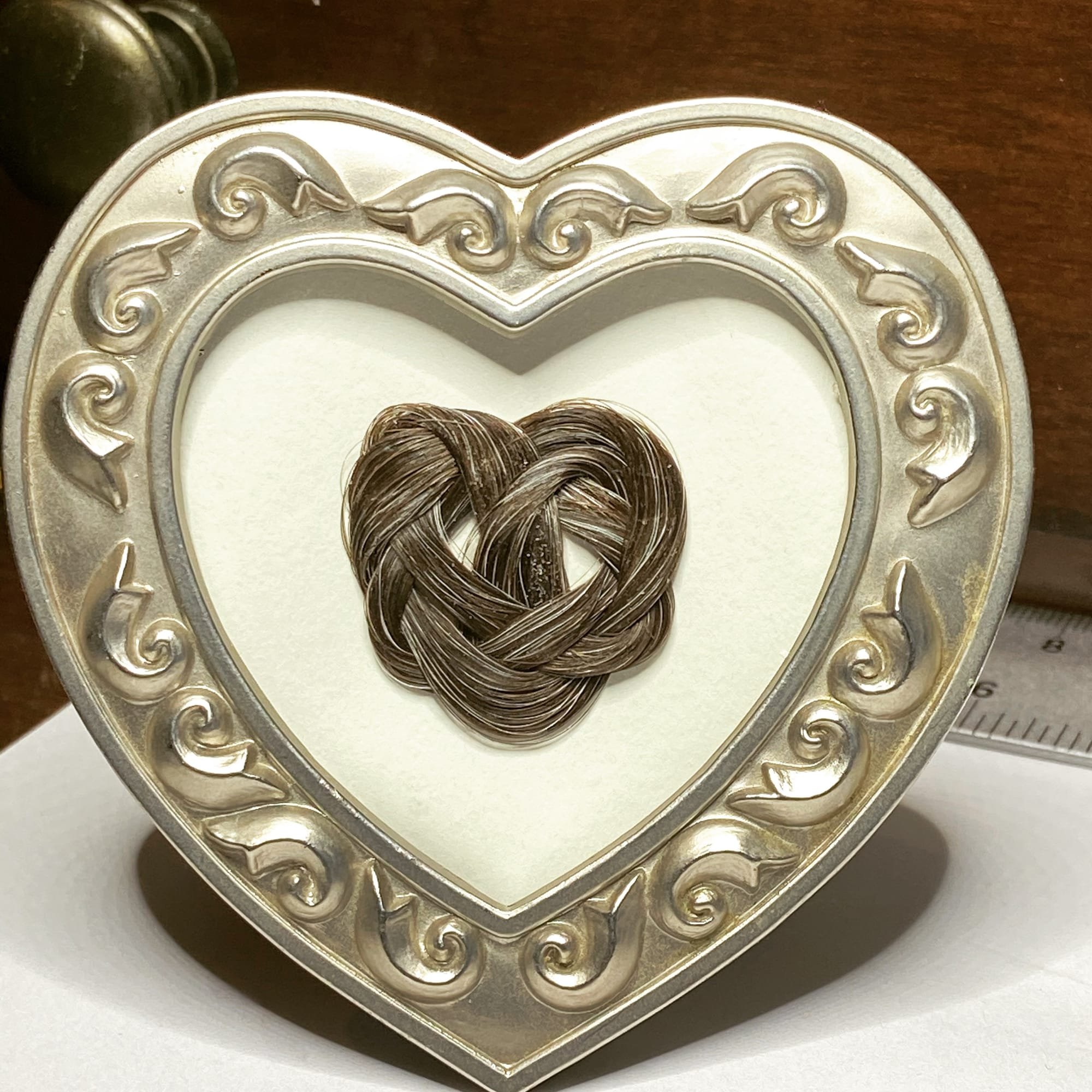 A Celtic heart knot in the silver strands of a Mother