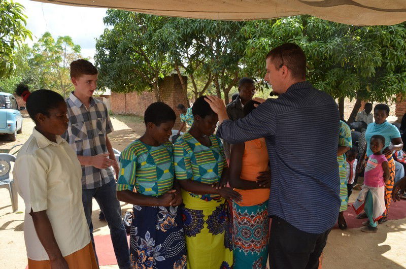 Pastor Aaron praying for the sick