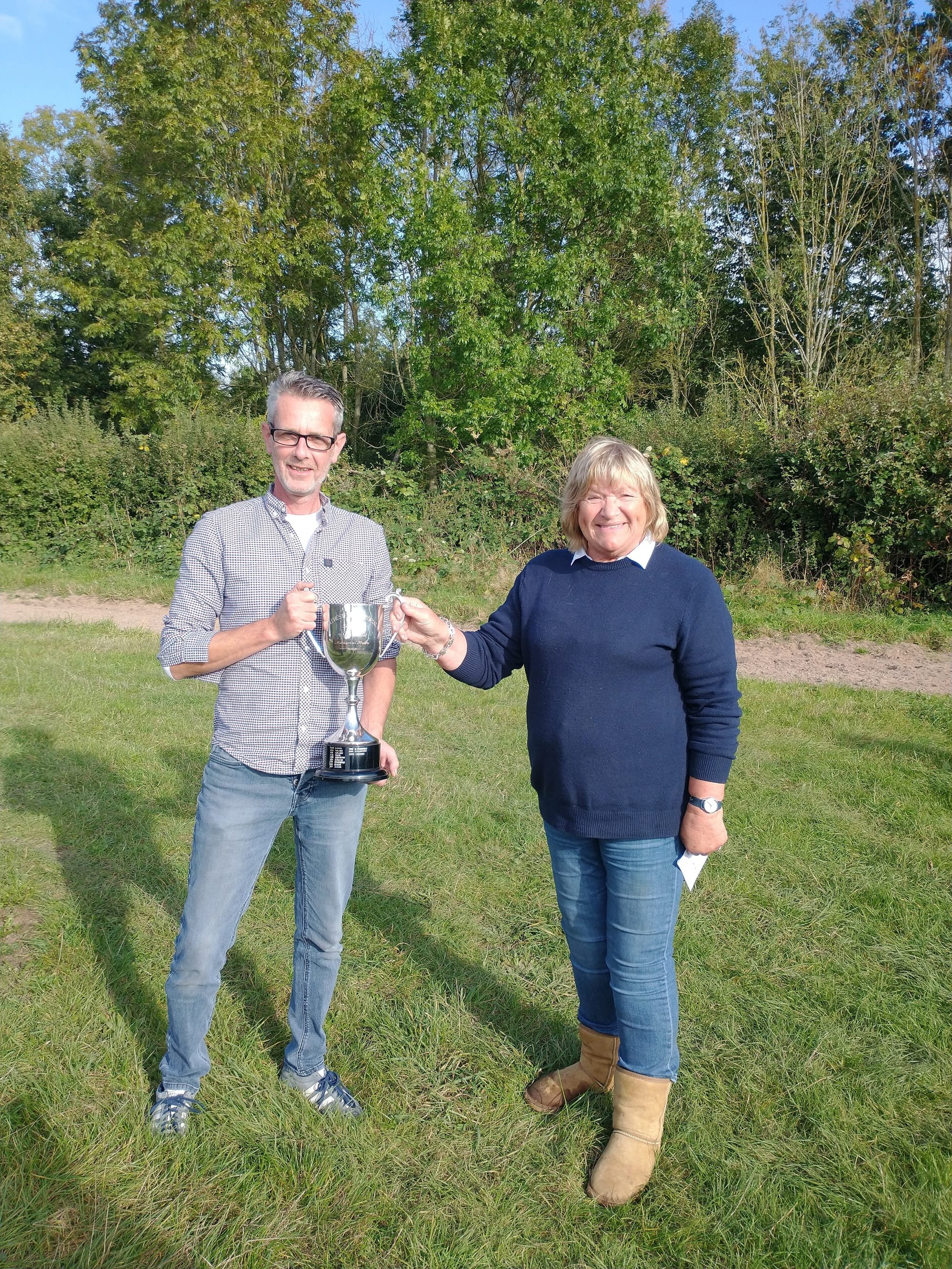 Ann Tolhurst presenting the Wilf Tolhurst Memorial Trophy to the winner John Popkin on Sunday 17th October 2021