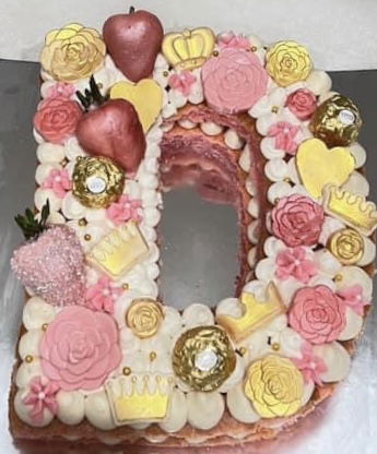 2 Layer Vanilla Rose Gold Letter D Birthday Cake with Buttercream Frosting, Chocolate Covered Strawberries, and Candy Appliqué