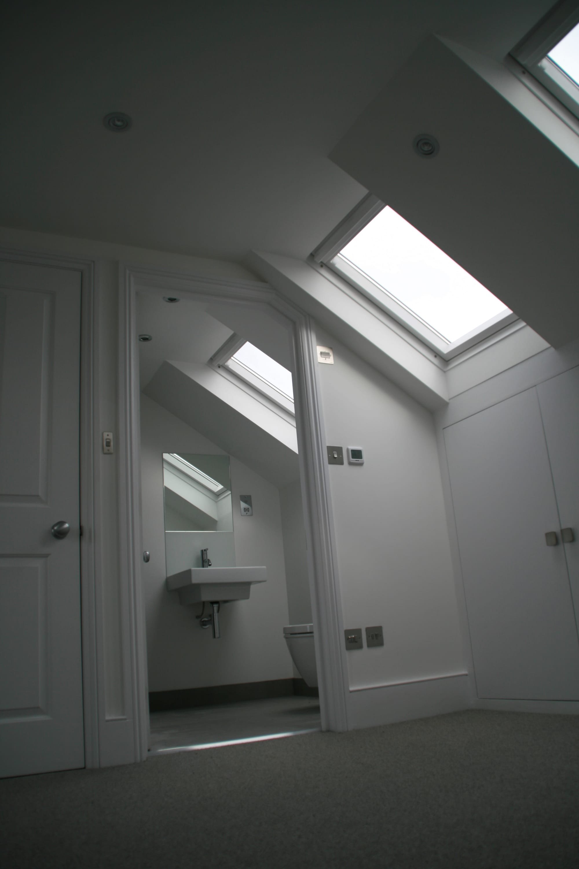 Velux windows maximise the natural light into both loft bedroom and en-suite shower room in this SW11 loft conversion extension