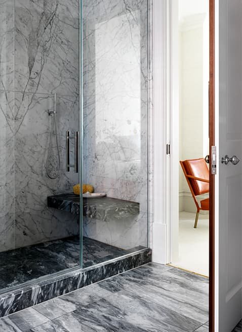 Large format custom marble shower enclosure with floating bench seat in this SW3 riverside apartment refurbishment.