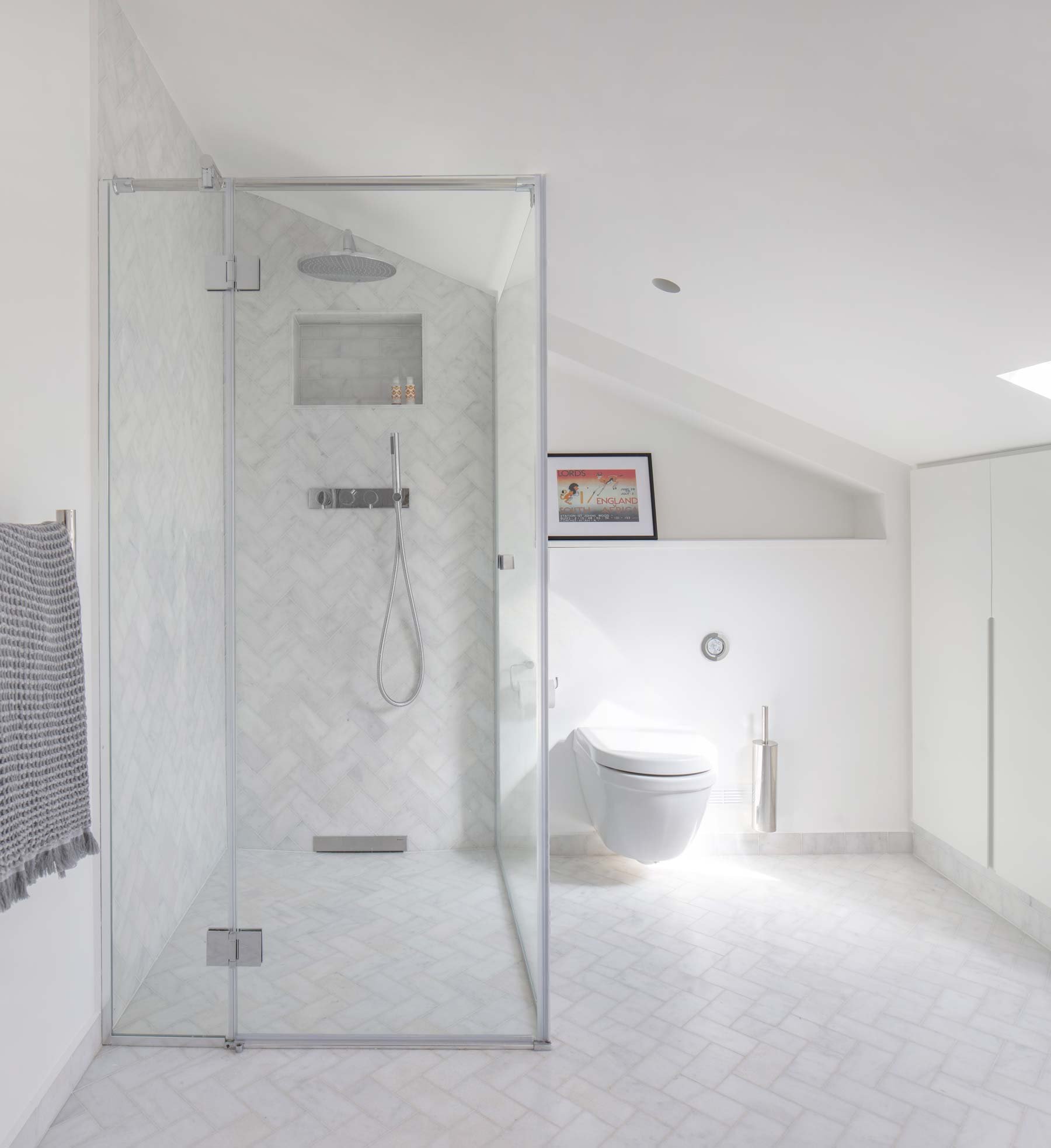 Herringbone wall and floor tiles inb this loft conversion extension shower room in SW12, Wandsworth