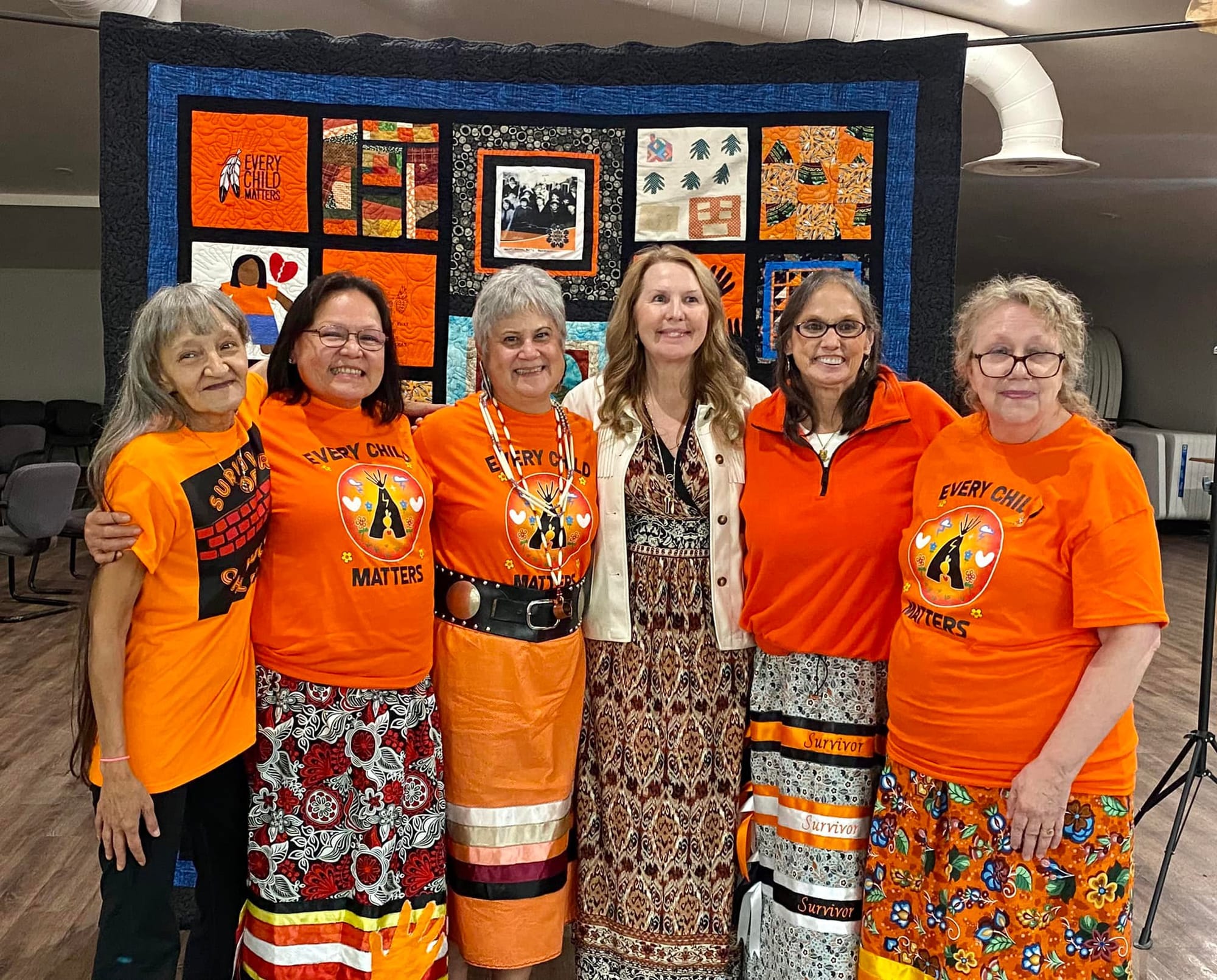 Survivors with their quilt