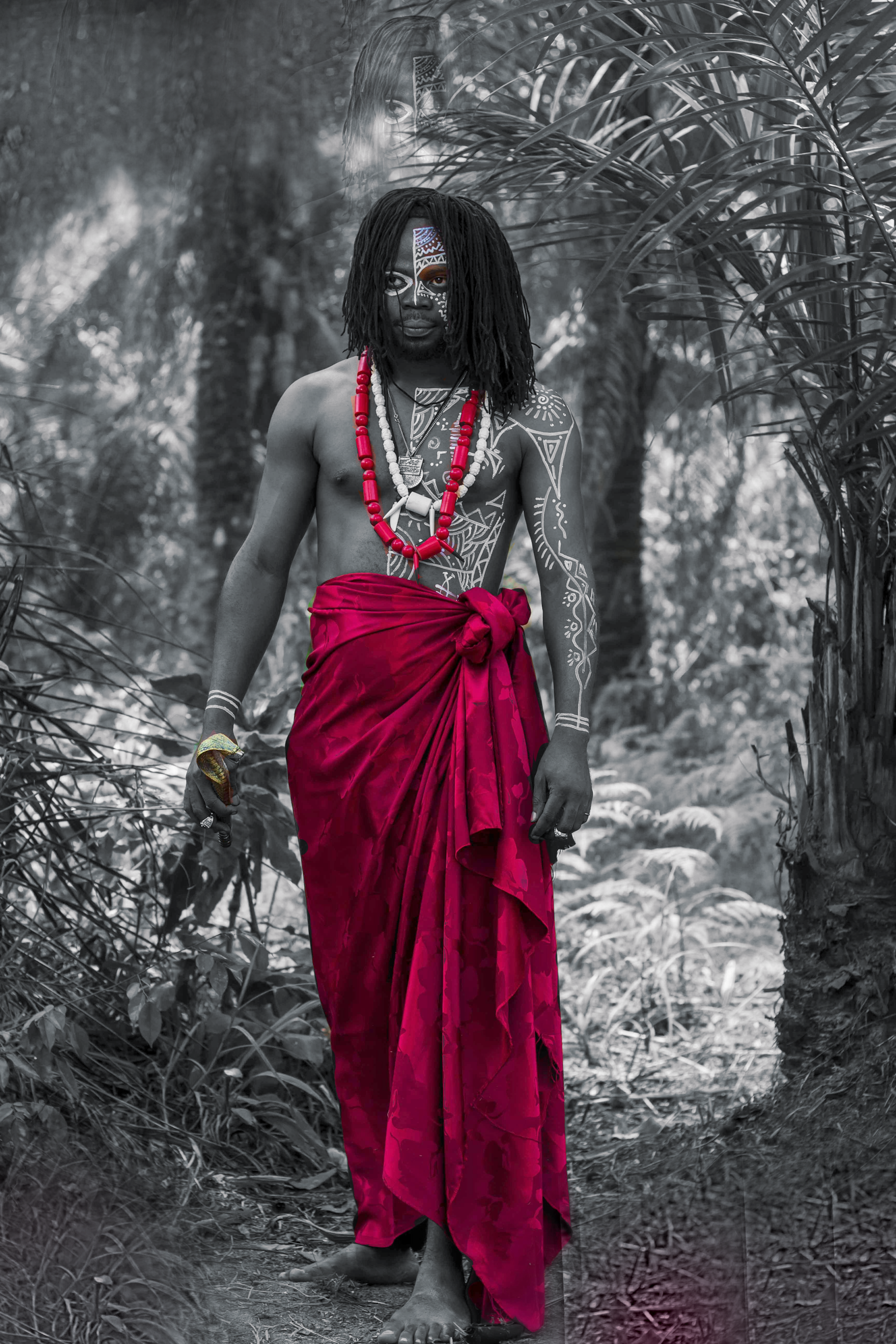 Oku strikes a pose in a traditional African priest attire