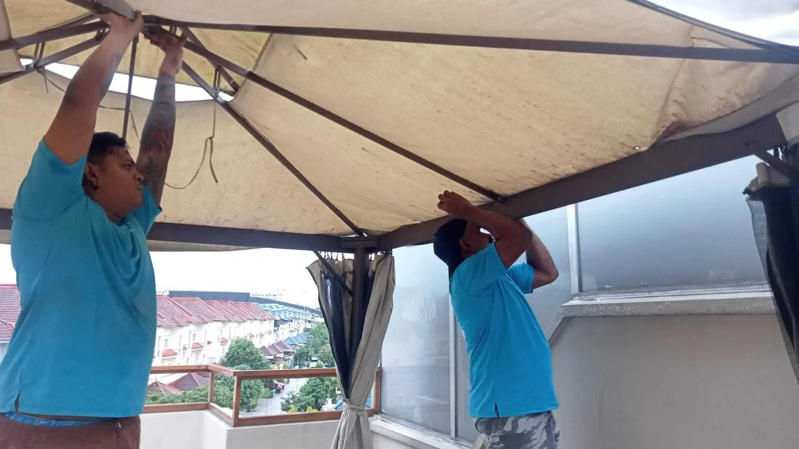 movers unscrewing outside tent