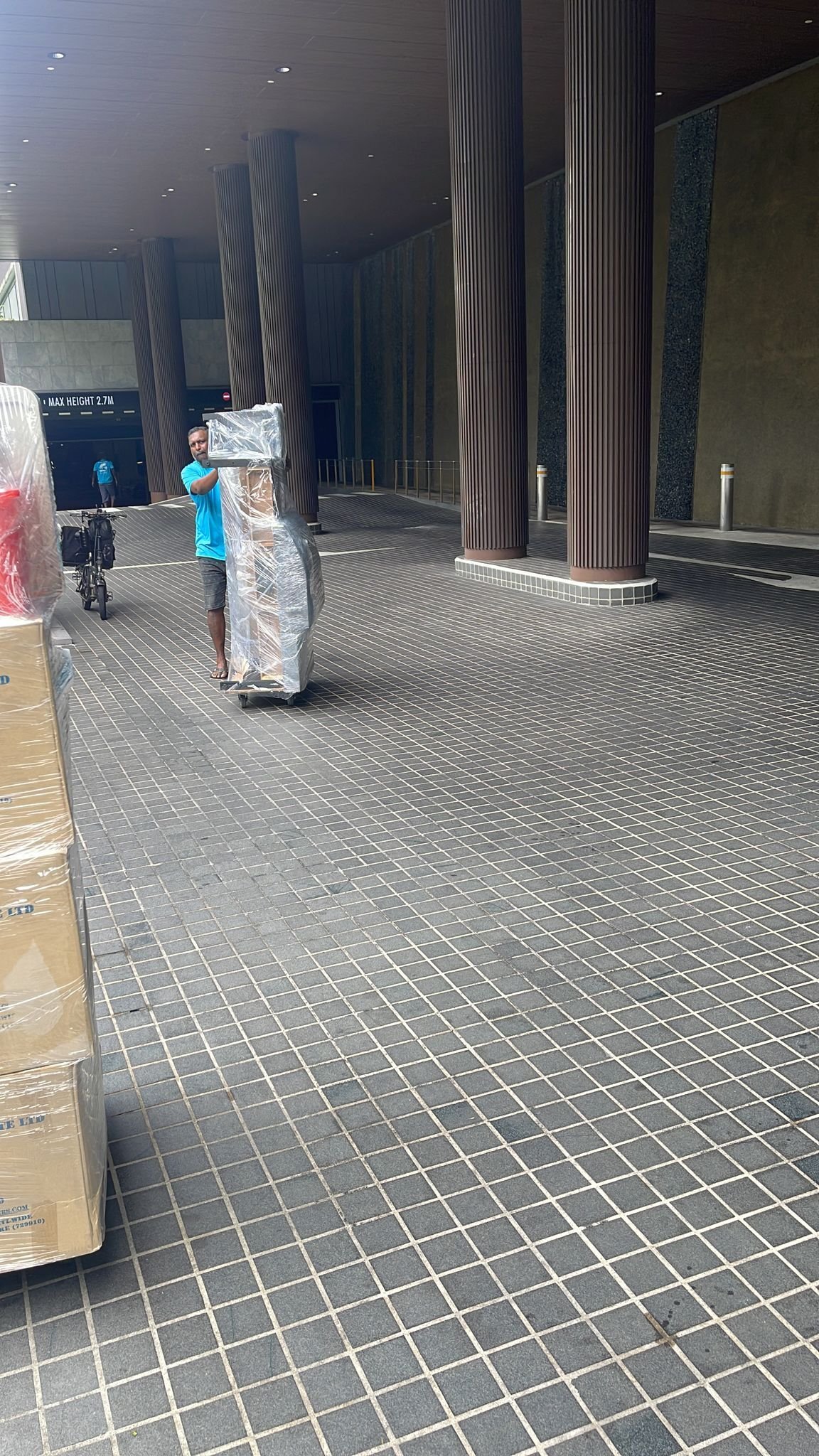 movers pushing trolley across carpark