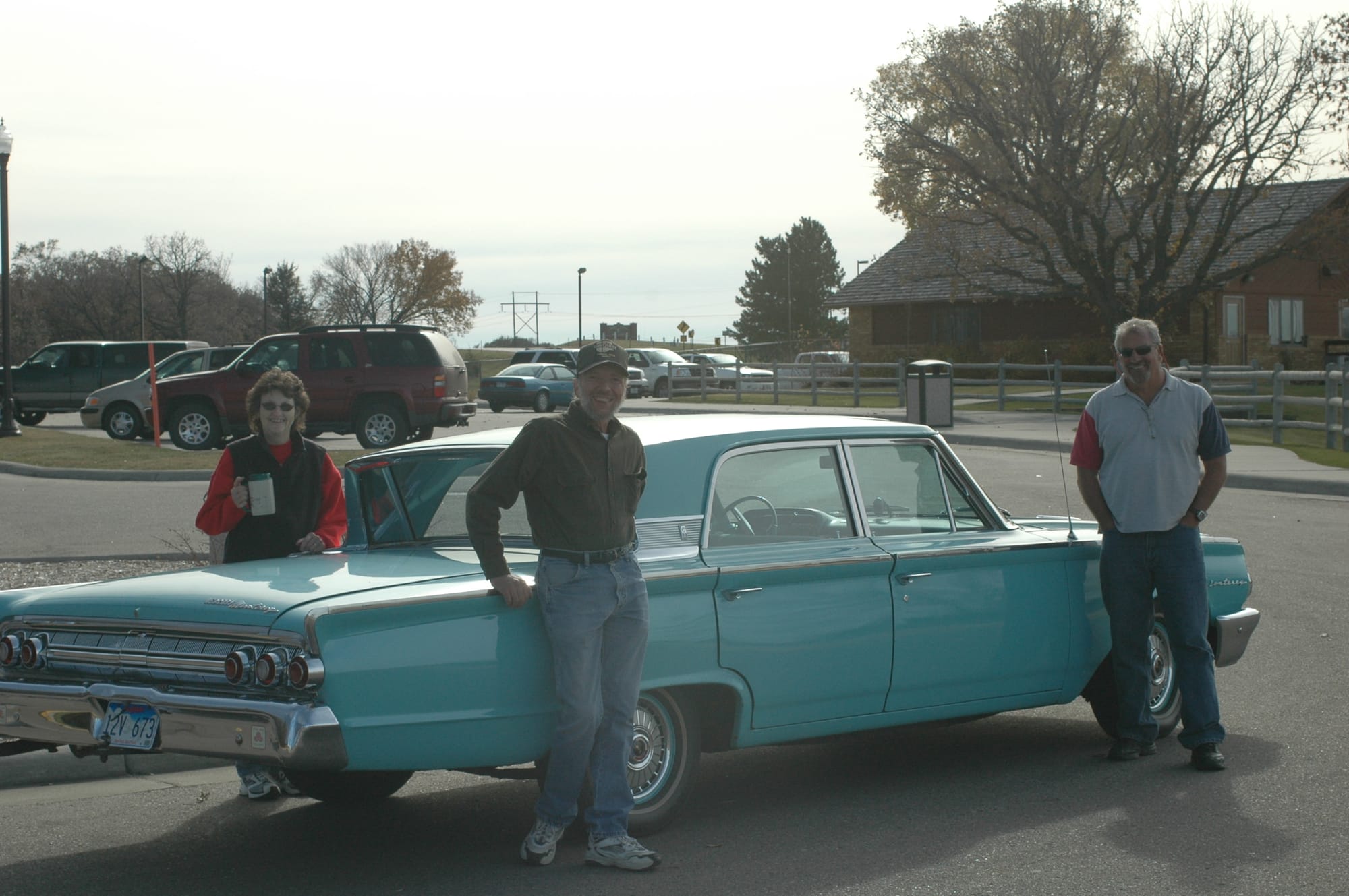 Ken, Bev, John with the Merc. Mom Viola’s car Kamps Memories Then