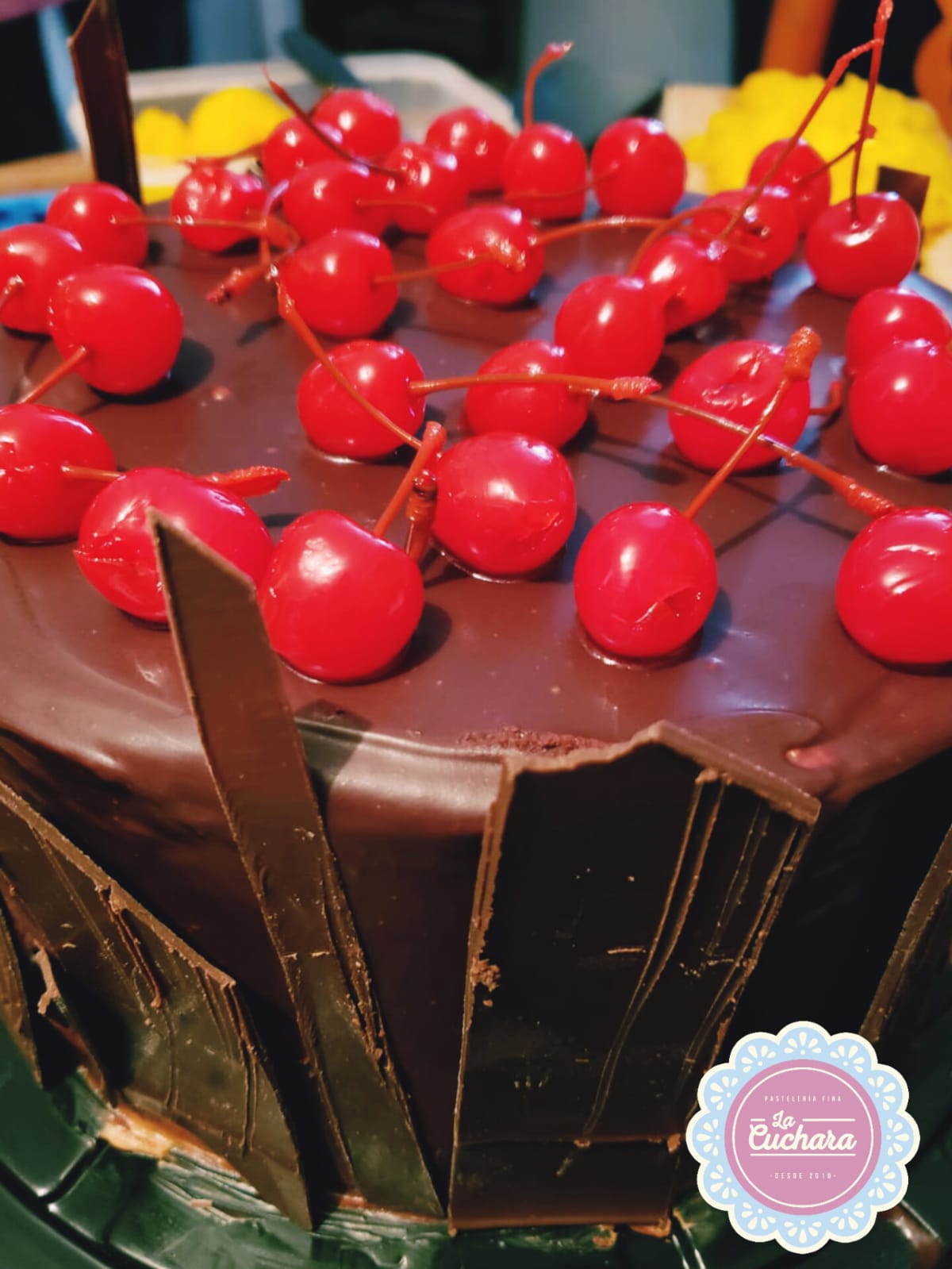 Pastel de tres chocolates y cereza relleno de almendra fileteada y mousse de chocolate