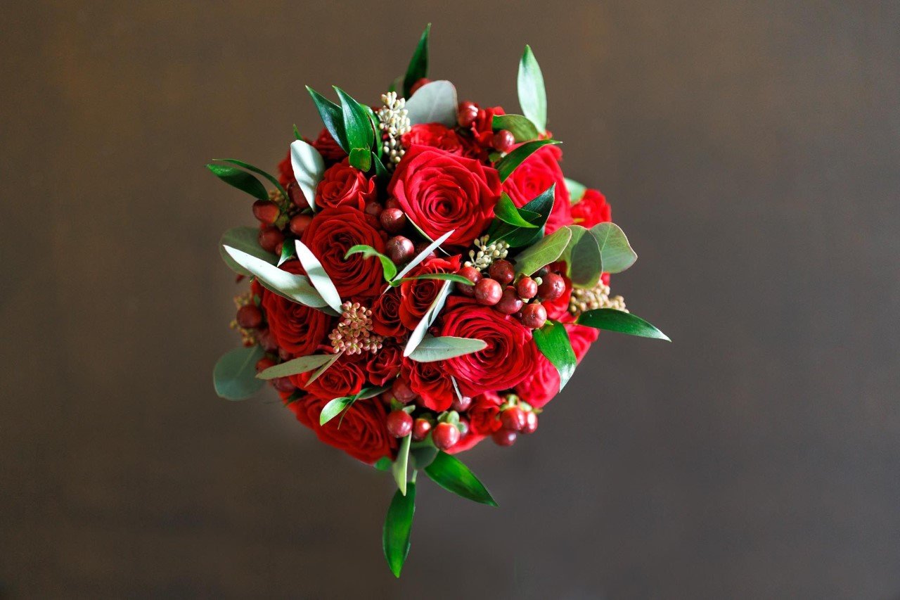 Red roses, berries and foliage hand-tie Bouquet